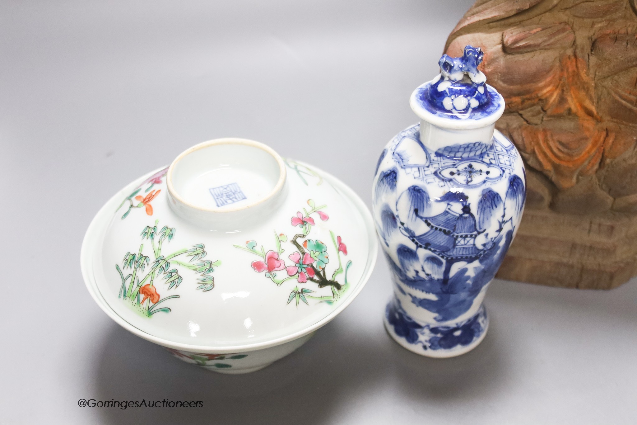 A 20th century carved wooden Buddha, height 34cm, a 19th century Chinese blue and white lidded vase, and a famille rose bowl and cover